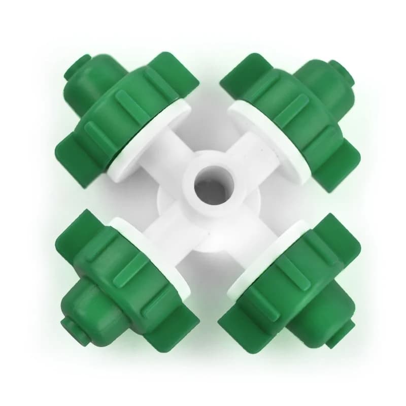 Green four-outlet misting nozzle viewed from above