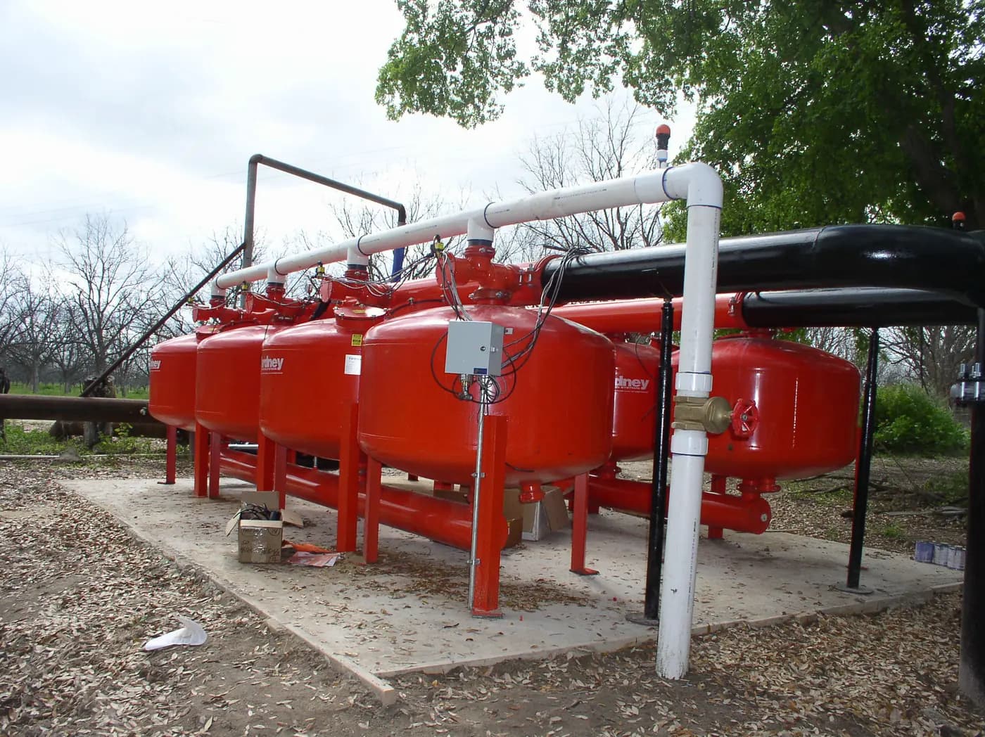 Irrigation filtration pipework and a valve connection at an orchard water-supply station in Texas