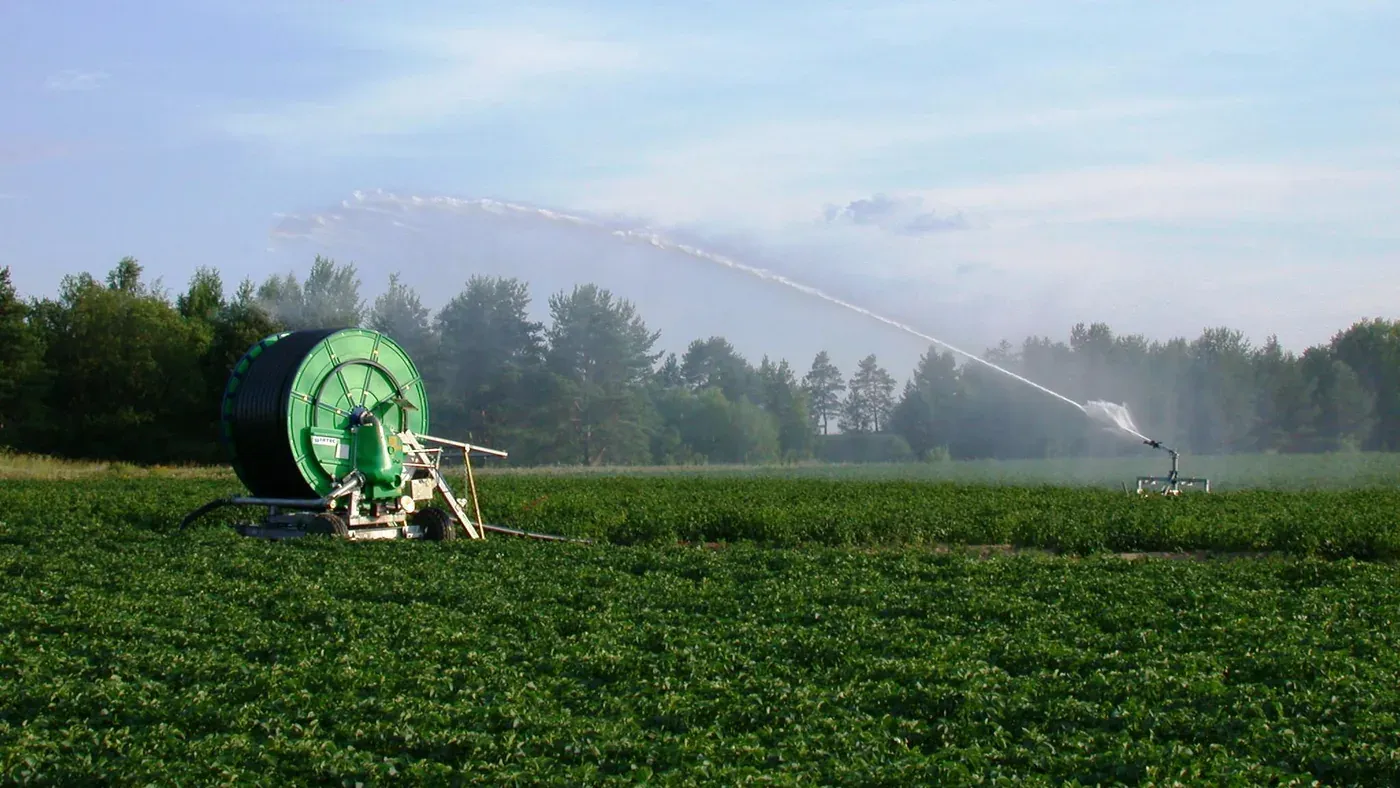 Carretel de mangueira e canhão de irrigação regando um campo perto de Motala, Suécia